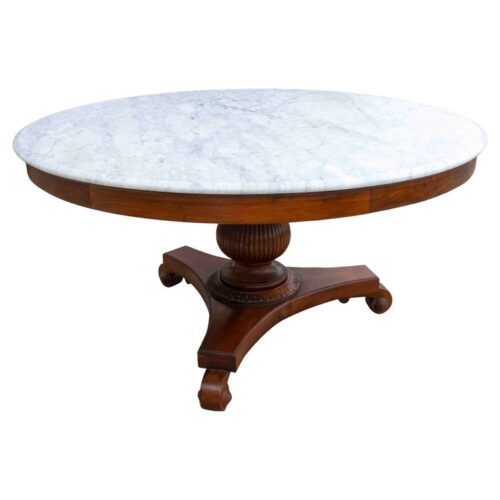Mesa de comedor redonda con tablero de mármol y base tallada. Años 50.